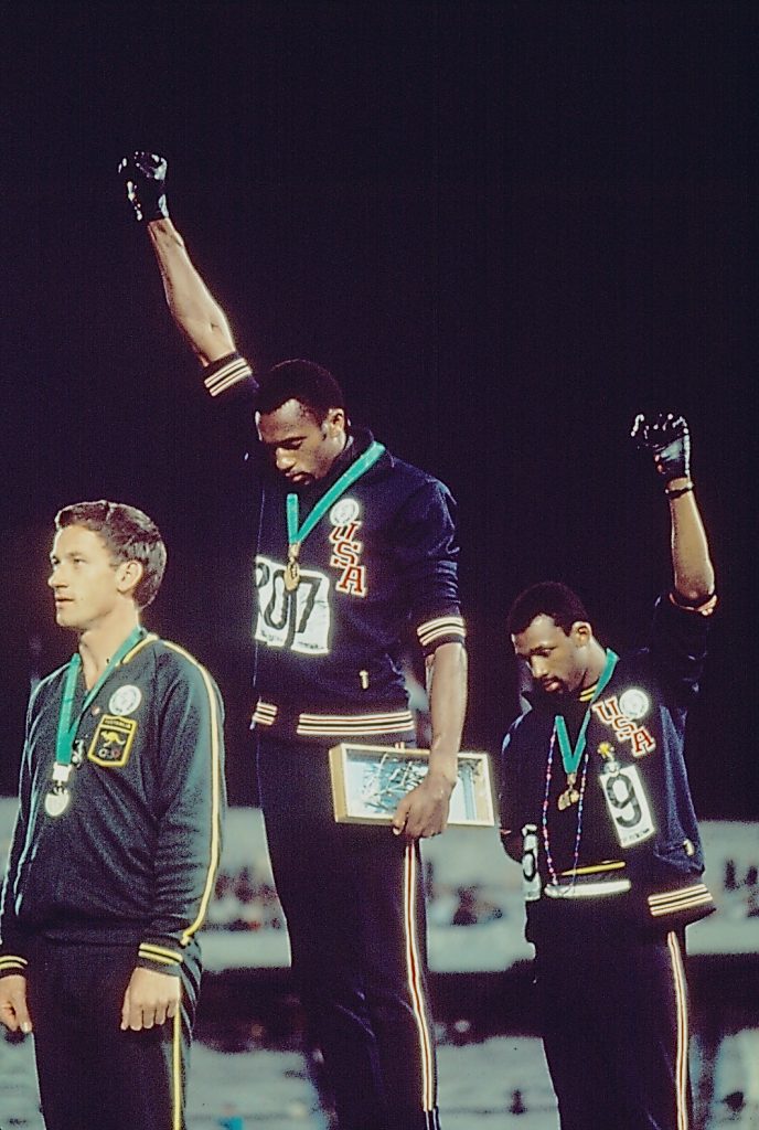 Tommie Smith (center) and John Carlos (right)